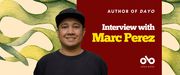 Interview with Marc Perez banner. Image of author smiling in baseball cap at forefront, with red block to right overlaid with text and the Open Book logo. Background of coloured shapes and tendrils from book cover.