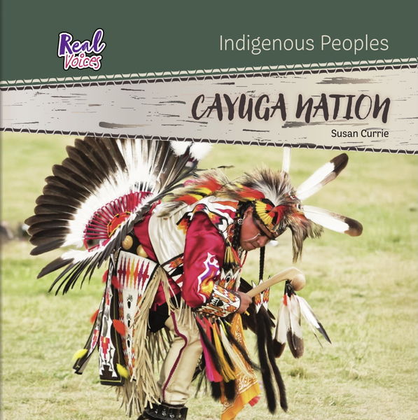 Book cover for Cayuga Nation by Susan Currie, part of the “Real Voices: Indigenous Peoples” series. The cover features a dancer dressed in traditional regalia with vibrant red, white, yellow, and black colors, adorned with feathers and beadwork. The dancer is captured mid-motion on a grassy field, holding a decorated stick. The title appears on a beige banner across the top, with a green background above it. Book cover for Cayuga Nation by Susan Currie, part of the “Real Voices: Indigenous Peoples” series. The cover features a dancer dressed in traditional regalia with vibrant red, white, yellow, and black colors, adorned with feathers and beadwork. The dancer is captured mid-motion on a grassy field, holding a decorated stick. The title appears on a beige banner across the top, with a green background above it.