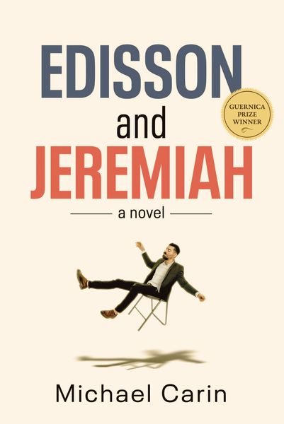 Book cover for Edisson and Jeremiah: A Novel by Michael Carin. The title features bold blue and red text on a white background, with a gold seal reading “Guernica Prize Winner” near the top right. Below the title, a man in a suit is shown falling backward in a chair, his arms and legs flailing, casting a shadow on the ground beneath him. Book cover for Edisson and Jeremiah: A Novel by Michael Carin. The title features bold blue and red text on a white background, with a gold seal reading “Guernica Prize Winner” near the top right. Below the title, a man in a suit is shown falling backward in a chair, his arms and legs flailing, casting a shadow on the ground beneath him.