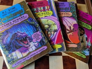 A set of four R.L. Stine's Give Yourself Goosebumps books, fanned out.