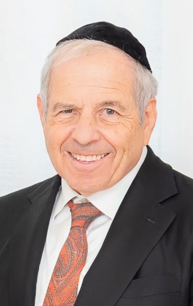 Author photo of Jerry Faivish (Photo by Sonya Kaplan Photography). An older man smiling warmly, wearing a black suit jacket, white dress shirt, and patterned orange tie. He has short gray hair and is wearing a black kippah. The background is softly lit in white tones. Author photo of Jerry Faivish (Photo by Sonya Kaplan Photography). An older man smiling warmly, wearing a black suit jacket, white dress shirt, and patterned orange tie. He has short gray hair and is wearing a black kippah. The background is softly lit in white tones.