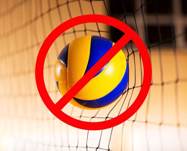 Photo of a volleyball against a net with a 'no parking' style crossout over the volleyball