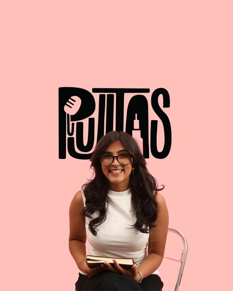 Author photo of Pujita Verma. Author seated on a chair against a solid pink background, smiling and holding an open book. She has long dark hair, wears glasses, and is dressed in a white sleeveless top and dark pants. Behind her, large stylized black text spells “PUJITA” with a microphone graphic incorporated into the design.