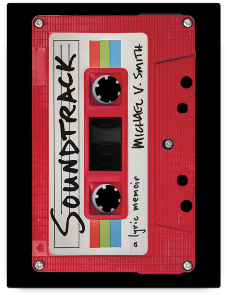 Book cover for Soundtrack: A Lyric Memoir by Michael V. Smith. The design features a red cassette tape with a white label and rainbow stripes. The word “Soundtrack” is handwritten across the label, with “Michael V. Smith” written vertically on the side and “a lyric memoir” at the bottom. The cassette is shown against a black background.