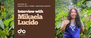 interview with Mikaela Lucido, author of Danica dela Torre, Certified Sleuth banner. Background image of dense woodland greenery with author to right of banner standing in forefront, young woman with long black hair, wearing a blue dress and smiling outwardly. Solid burgundy area to centre left with text and Open Book logo overlaid.