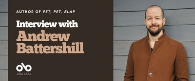 Interview with Andrew Battershill banner. Background image of wooden siding on house with author to the right of the banner, young man standing with hands in his pockets with a short beard and cropped hair, wearing a stylish button-down jacket and leaning against wall. Solid red area to the centre left of image with text and Open Book logo overlaid.