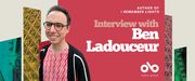Interview with Ben Ladouceur, author of I Remember Lights banner. Background from book cover of vertical geometric shapes rising in vertical columns with patterns and images contained within. Solid pink section to centre with text and Open Book logo overlaid. Image of the author to centre left, young man with glasses and short dark hair, smiling outwardly and wearing a pink, patterned shirt under a black pullover.