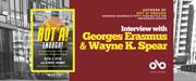 Interview with Wayne K. Spear and Georges Erasmus, authors of Hòt'a! Enough!: Georges Erasmus's Fifty-Year Battle for Indigenous Rights banner. Background image from cover, black and white photo of housing block with various buildings and a concrete and grass courtyard with sparse trees. Solid red section to centre right of banner with text and Open Book logo overlaid. Image of book cover to centre left, with the aforementioned image of the urban neighbourhood and the author, Georges Erasmus, standing with back to camera in foreground and looking out toward buildings, man with thick, grey hair and wearing a rugged, beige, brushed leather jacket in a traditional style.