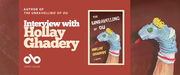 Banner for an interview with author Hollay Ghadery, featuring the cover of her book The Unravelling of Ou. The design has a dark red background with white and yellow text that reads “Interview with Hollay Ghadery.” The book cover shows a blue sock puppet with button eyes, a yellow yarn crown, and a red felt tongue. The Open Book logo appears at the bottom left.