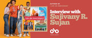 Book banner featuring the cover of I Am an Immigrant by Sujivany R. Sujan alongside a group of five smiling young people holding international flags against an orange background. On the right, white text on a red background reads: “Interview with Sujivany R. Sujan.” The Open Book logo appears below.