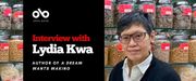Banner image with photo of author Lydia Kwa standing in front jars of dry goods in a Chinese grocery store. Text reads Interview with Lydia Kwa author of A Dream Wants Waking. open Book logo top left.