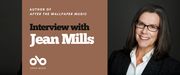 Interview with Jean Mills, author of After the Wallpaper Music banner. Background image author to right of banner. woman will long black hair and glasses, with a white blouse and suit jacket overtop, leaning slight and smiling against a dark textured backdrop. Solid green area to centre-left with text and Open Book logo overlaid.