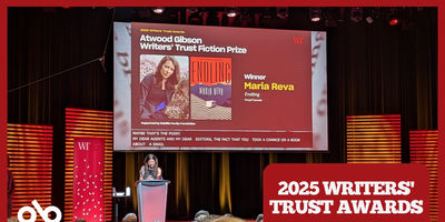 Banner showing the 2025 Writers’ Trust Awards ceremony. Author Maria Reva stands on stage at a podium, accepting the 2025 Atwood Gibson Writers’ Trust Fiction Prize for her book Endling. Behind her, a large screen displays her photo, the book cover, and text announcing her as the winner. The audience is seated in front of the stage, and the banner includes the event title “2025 Writers’ Trust Awards” in bold white text on a red background.